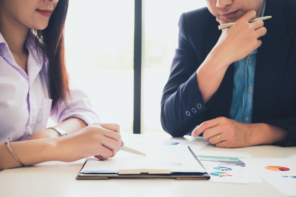 Business Adviser Analyzing and Discussing the Documents